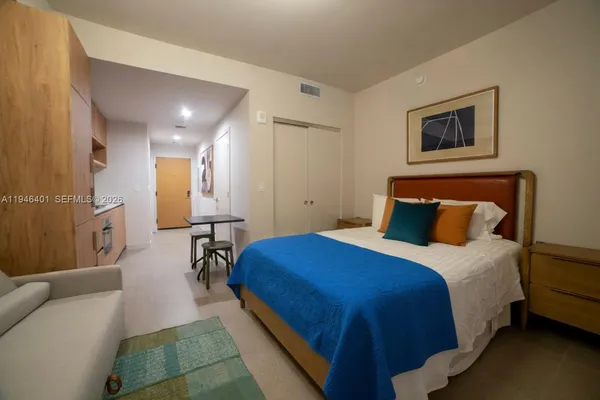 a spacious bedroom with a bed and a couch