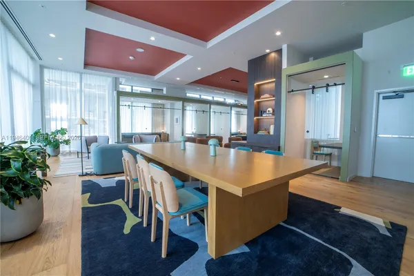 a lobby with furniture and a potted plant