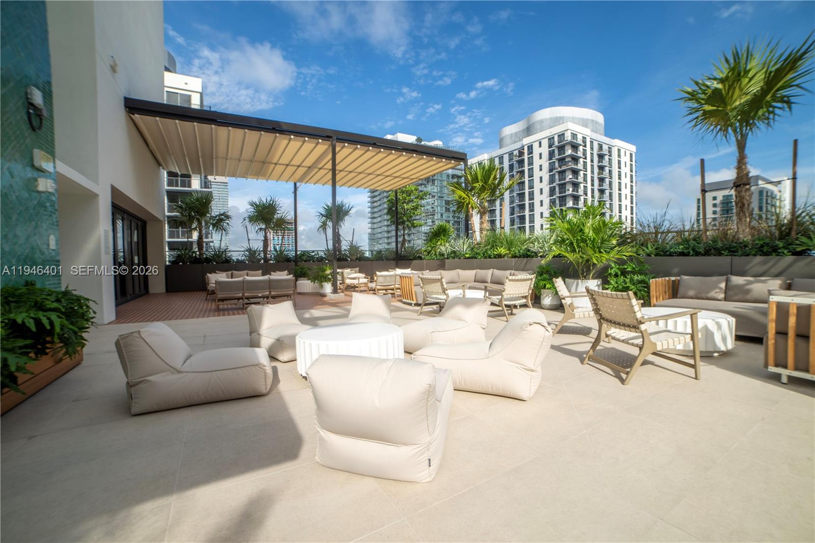 11 Northeast 6th Street, Unit 1908 Miami, FL 33132 - Photo 25 of 38 a view of a patio with couches and a table and chairs with potted plants