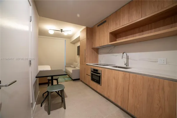 a kitchen with sink cabinets and stove top oven