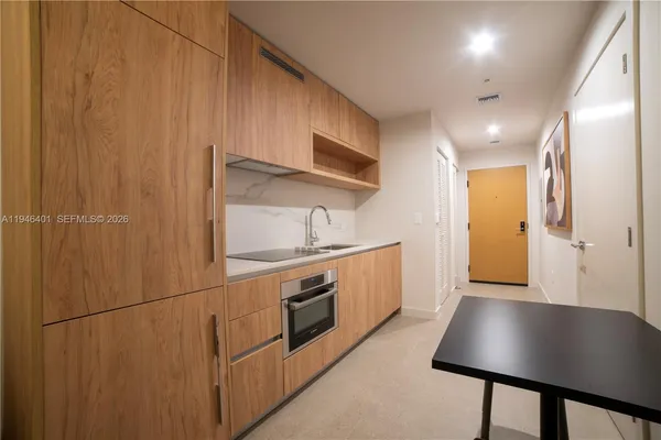 a kitchen with cabinets and stainless steel appliances