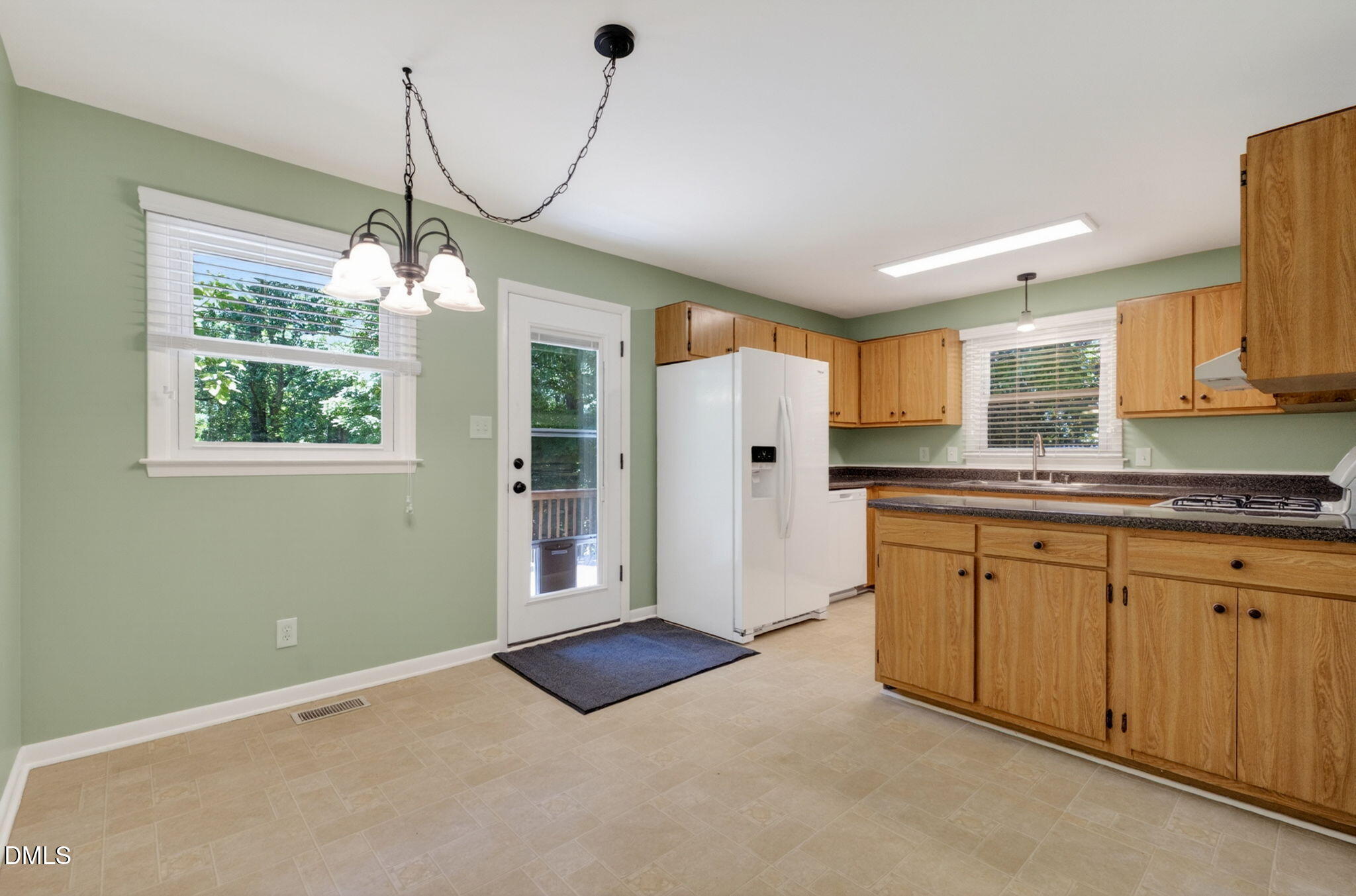 1224 Pineview Drive Raleigh, NC 27606 - Photo 10 of 45 a open kitchen with stainless steel appliances granite countertop a refrigerator and cabinets