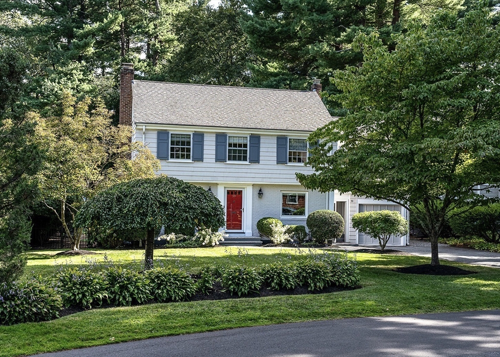 a aerial view of a house next to a yard