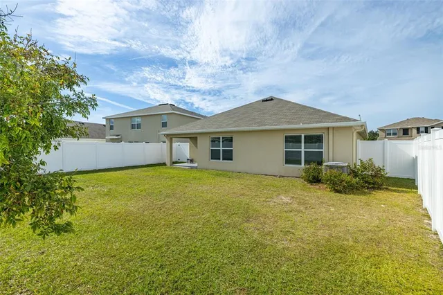 an aerial view of residential houses with outdoor space and ocean view