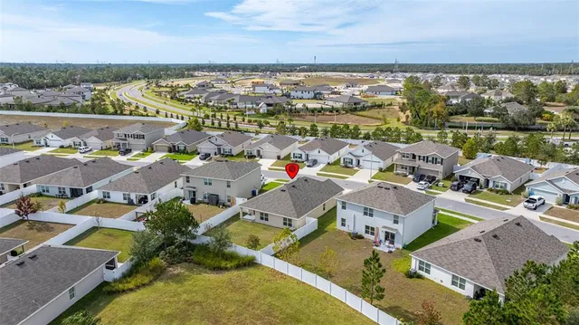 an aerial view of residential house with outdoor space and pool view
