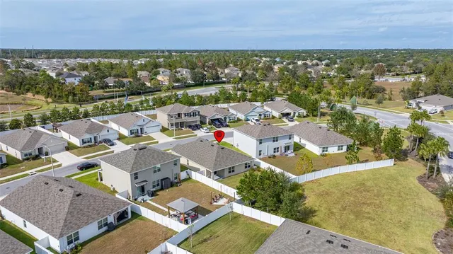 an aerial view of residential houses with outdoor space