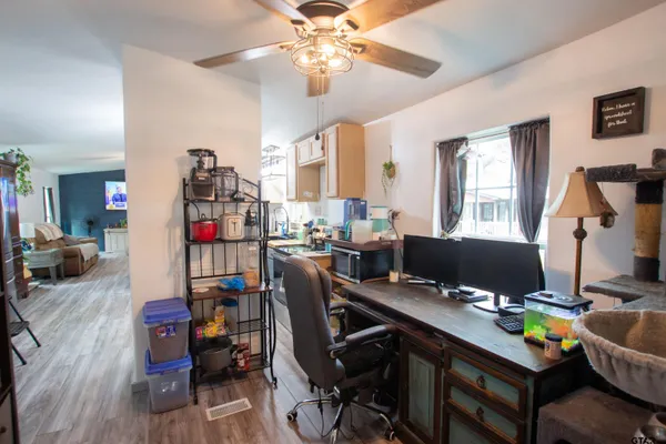 a view of a workspace with furniture and toys