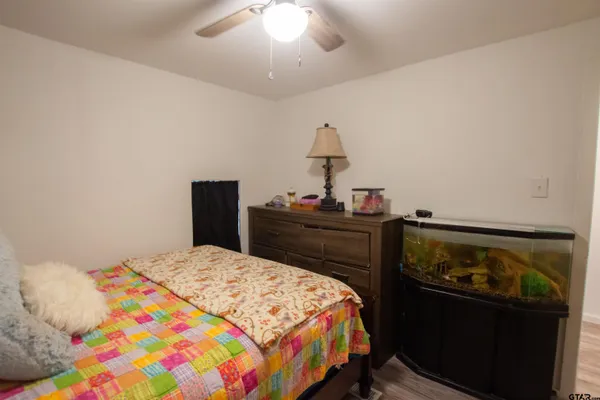 a bedroom with a bed and a dresser in it