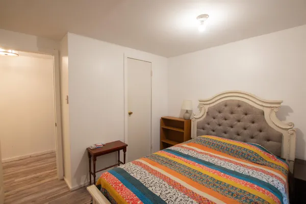 a bedroom with a bed and dresser