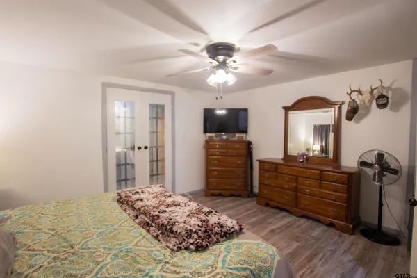 a bedroom with a bed and a chandelier