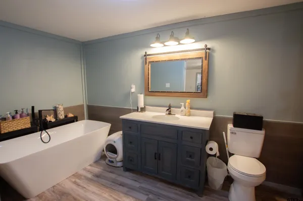 a bathroom with a double vanity sink mirror and toilet