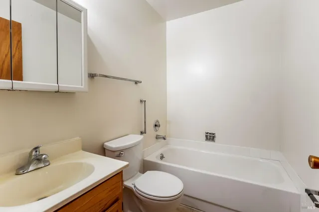 a bathroom with a sink a toilet and bathtub