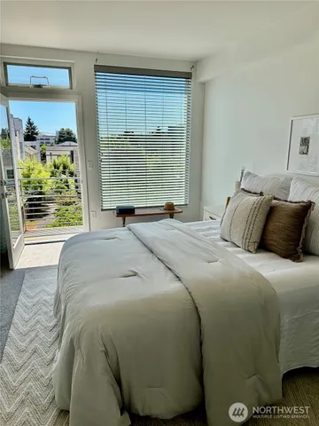 a bedroom with a bed and window