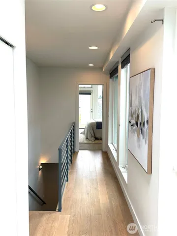 a view of hallway with wooden floor