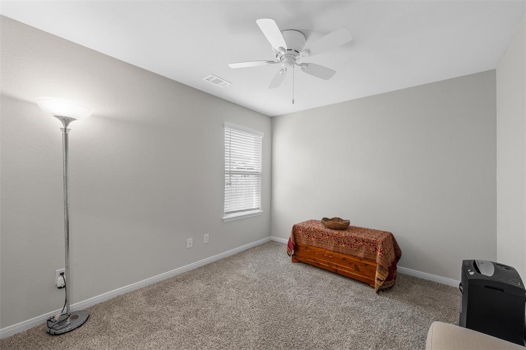 4056 Centerfire Road Waco, TX 76705 - Photo 20 of 27 a room with a lamp and a chandelier fan