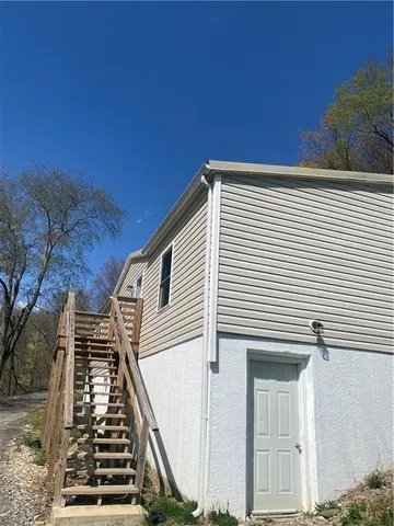 a view of a balcony with wooden floor and fence