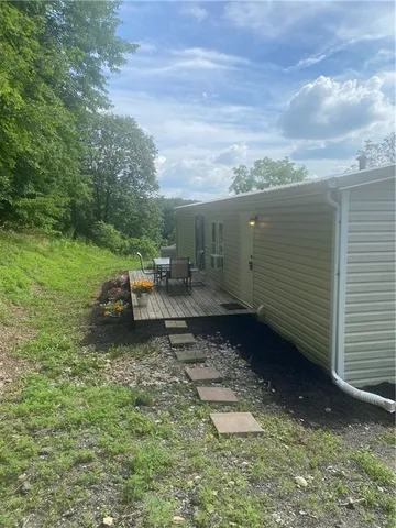 a backyard of a house with table and chairs
