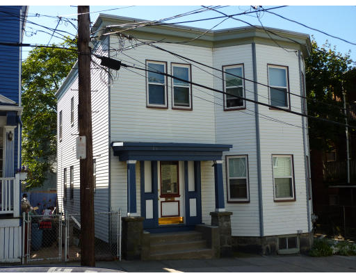 a view of a white house with many windows