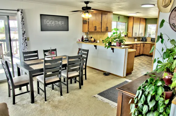 a view of a dining room with furniture and a potted plant