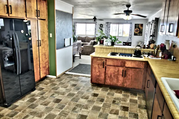 a kitchen with a stove a sink dishwasher and a refrigerator