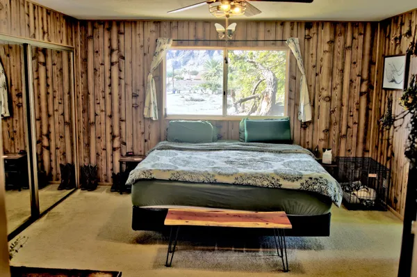 a bedroom with a bed and a window