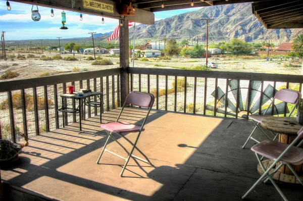 a view of a chairs and table in the balcony