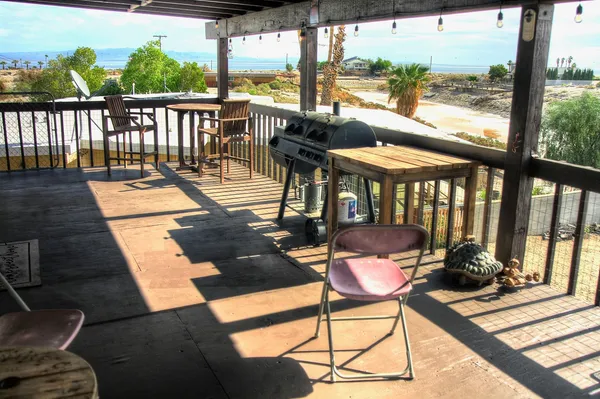 a view of a chairs and table in the balcony