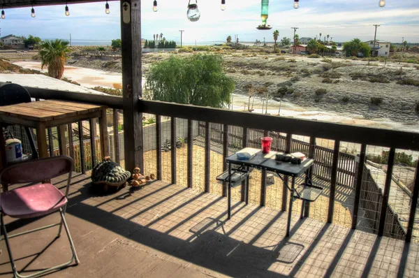 a view of a city from a balcony with furniture