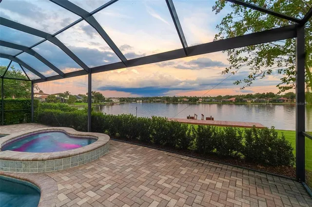 a front view of a house with a garden and trees