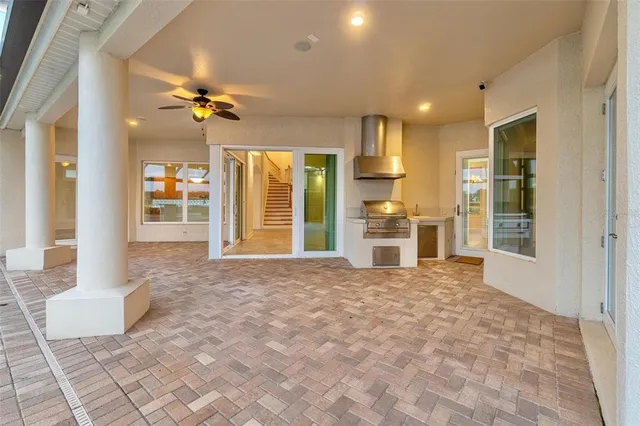 a large kitchen with stainless steel appliances granite countertop a stove and a sink