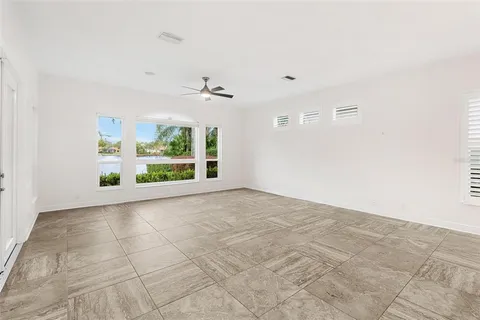 an empty room with windows and closet