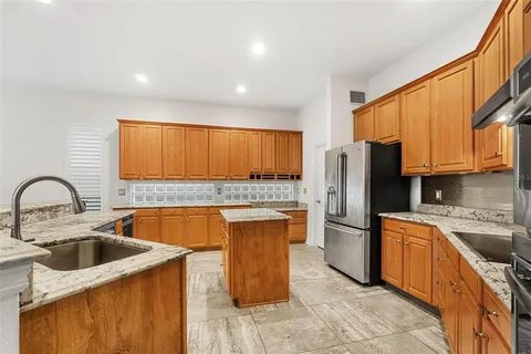 a bathroom with a bathtub a double vanity sink and mirrors