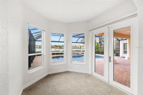 an empty room with a ceiling fan and closet area