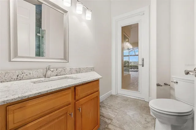 a bathroom with a double vanity sink toilet and shower