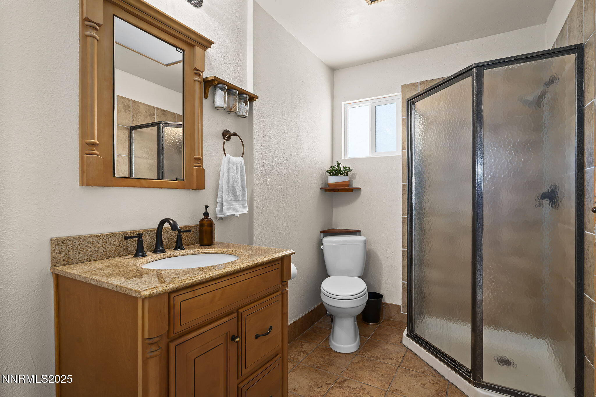 704 Roberts Street Reno, NV 89502 - Photo 17 of 52 a bathroom with a toilet sink and mirror