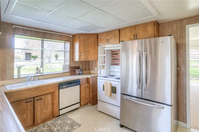 a kitchen with stainless steel appliances a refrigerator sink and cabinets