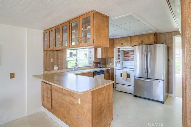 a kitchen with a refrigerator and a stove