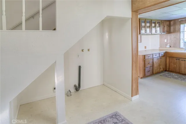 a spacious bedroom with a bed and a chandelier