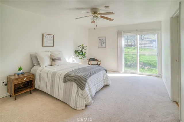 a bedroom with a bed and a potted plant