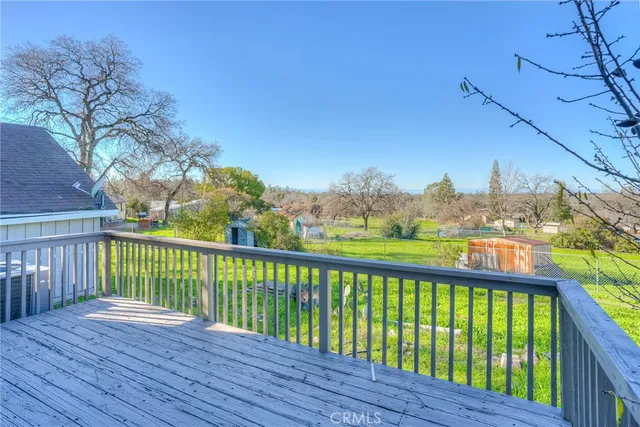 a view of a house with a big yard and large trees