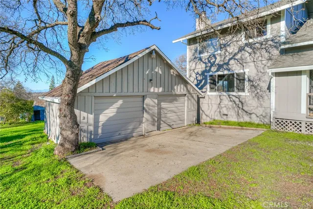 a view of backyard of house with green space