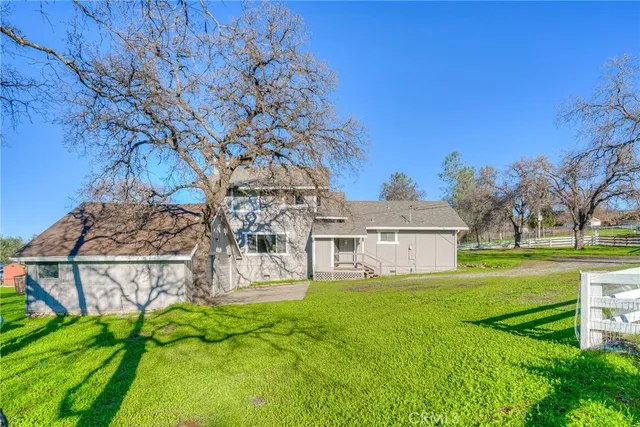 a view of a house with a yard and sitting area