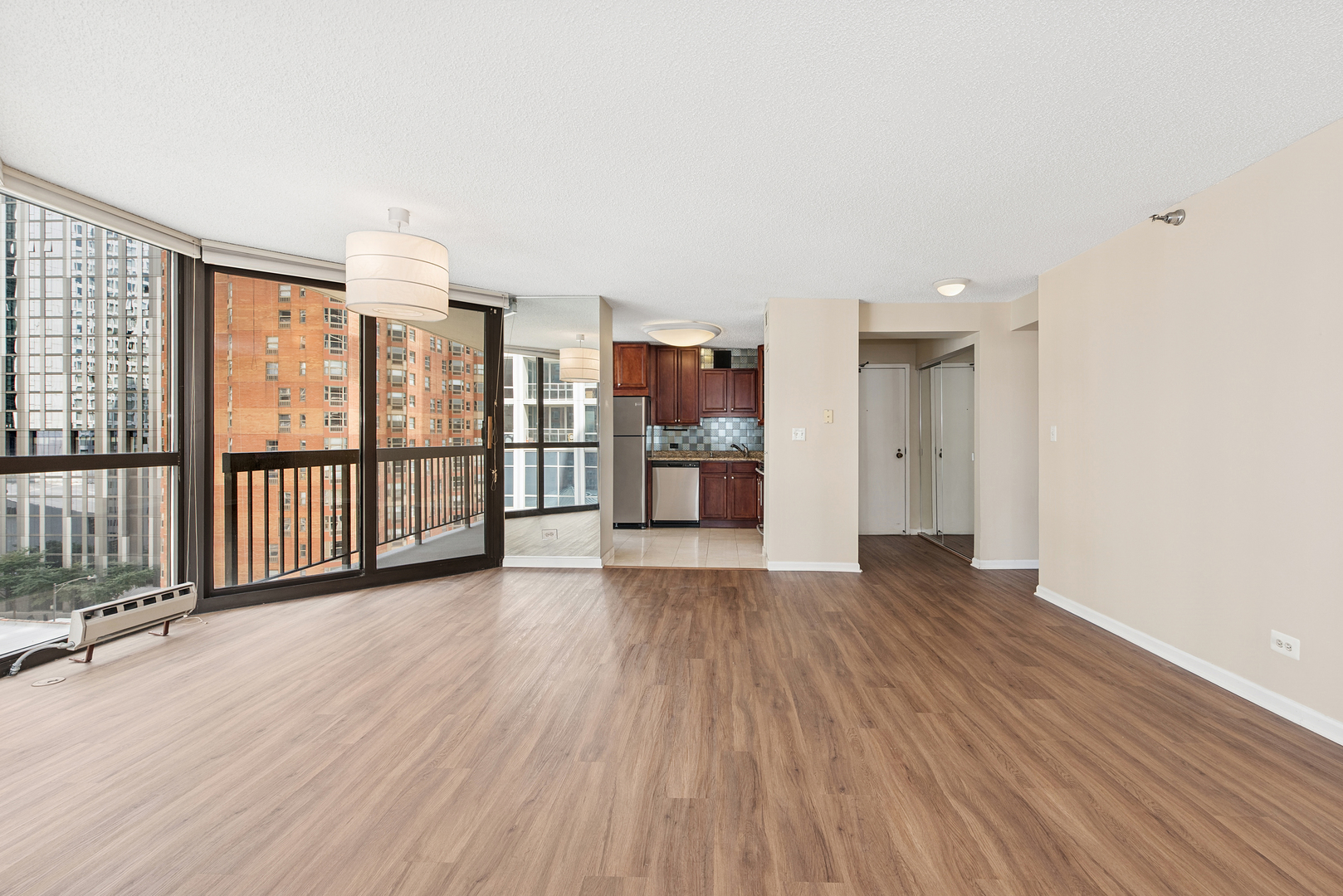33 West Delaware Place, Unit 10B Chicago, IL 60610 - Photo 14 of 19 an empty room with wooden floor and windows