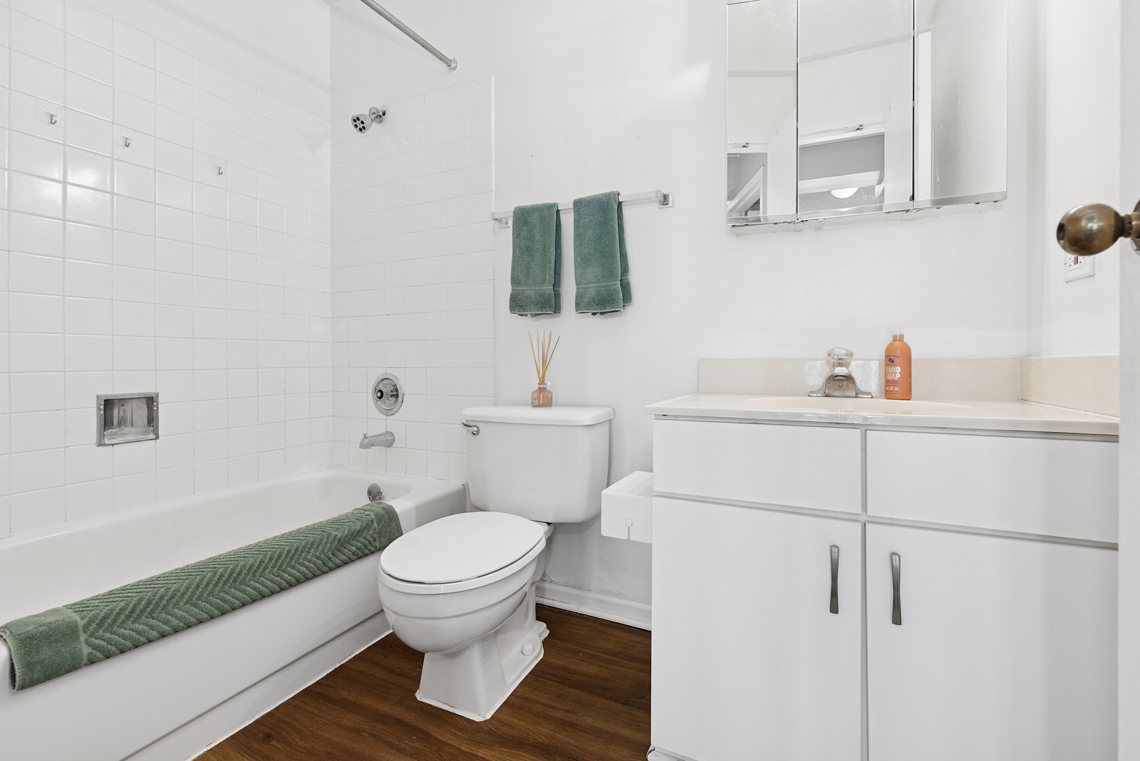 33 West Delaware Place, Unit 10B Chicago, IL 60610 - Photo 16 of 19 a bathroom with a sink toilet a mirror and vanity