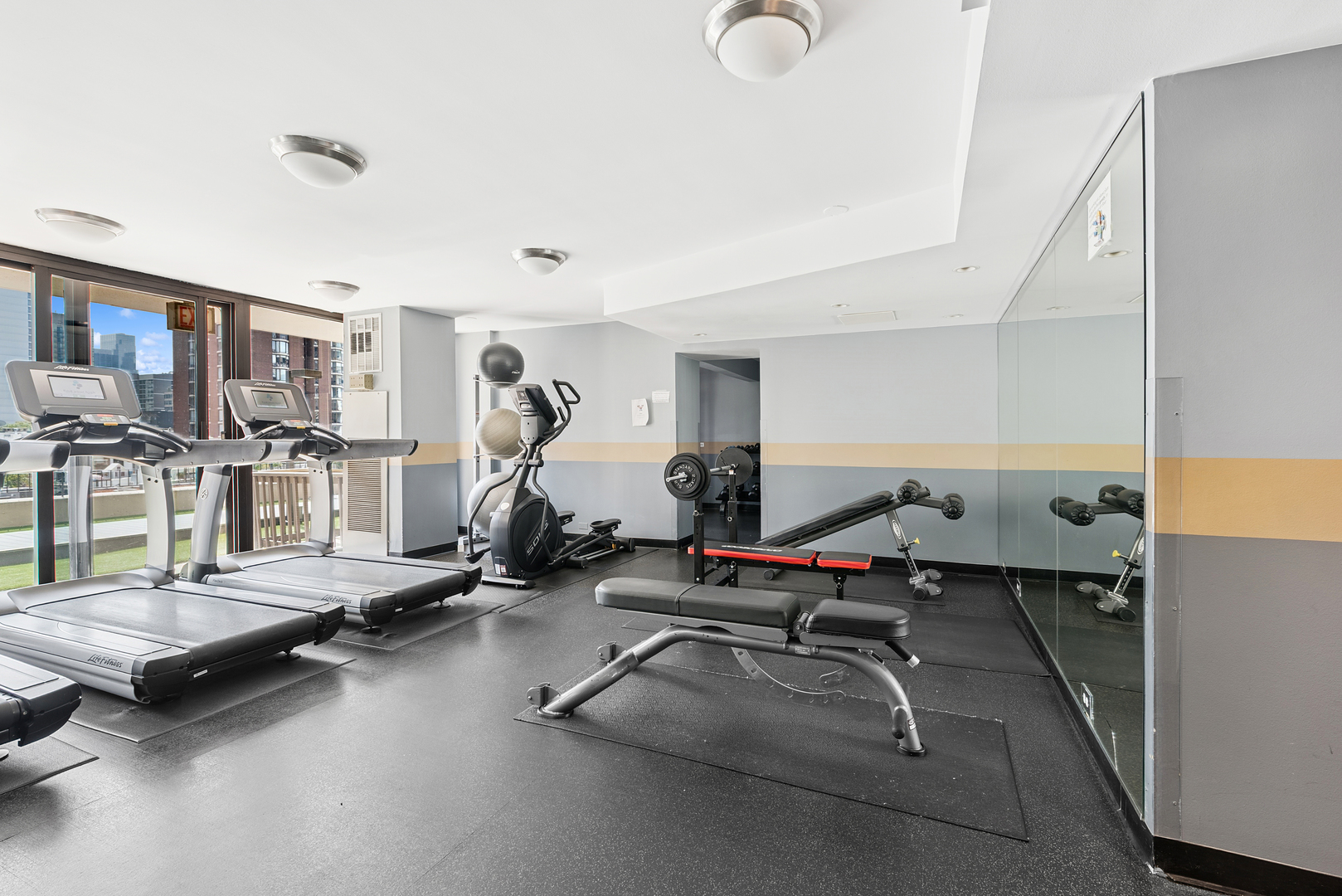 33 West Delaware Place, Unit 10B Chicago, IL 60610 - Photo 17 of 19 a room with gym equipment and a table