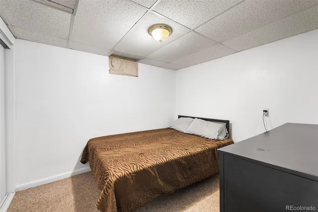 a bedroom with a bed and a night stand