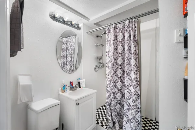 a bathroom with a sink toilet and a shower