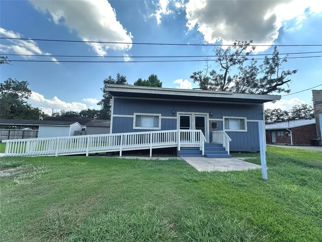 a front view of a house with a yard and porch