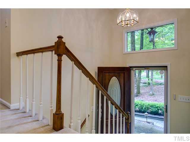 5822 Scalybark Road Durham, NC 27712 - Photo 5 of 25 A sturdy storm door protects the wooden door at the entrance. The foyer floor is ceramic tile. Foyer