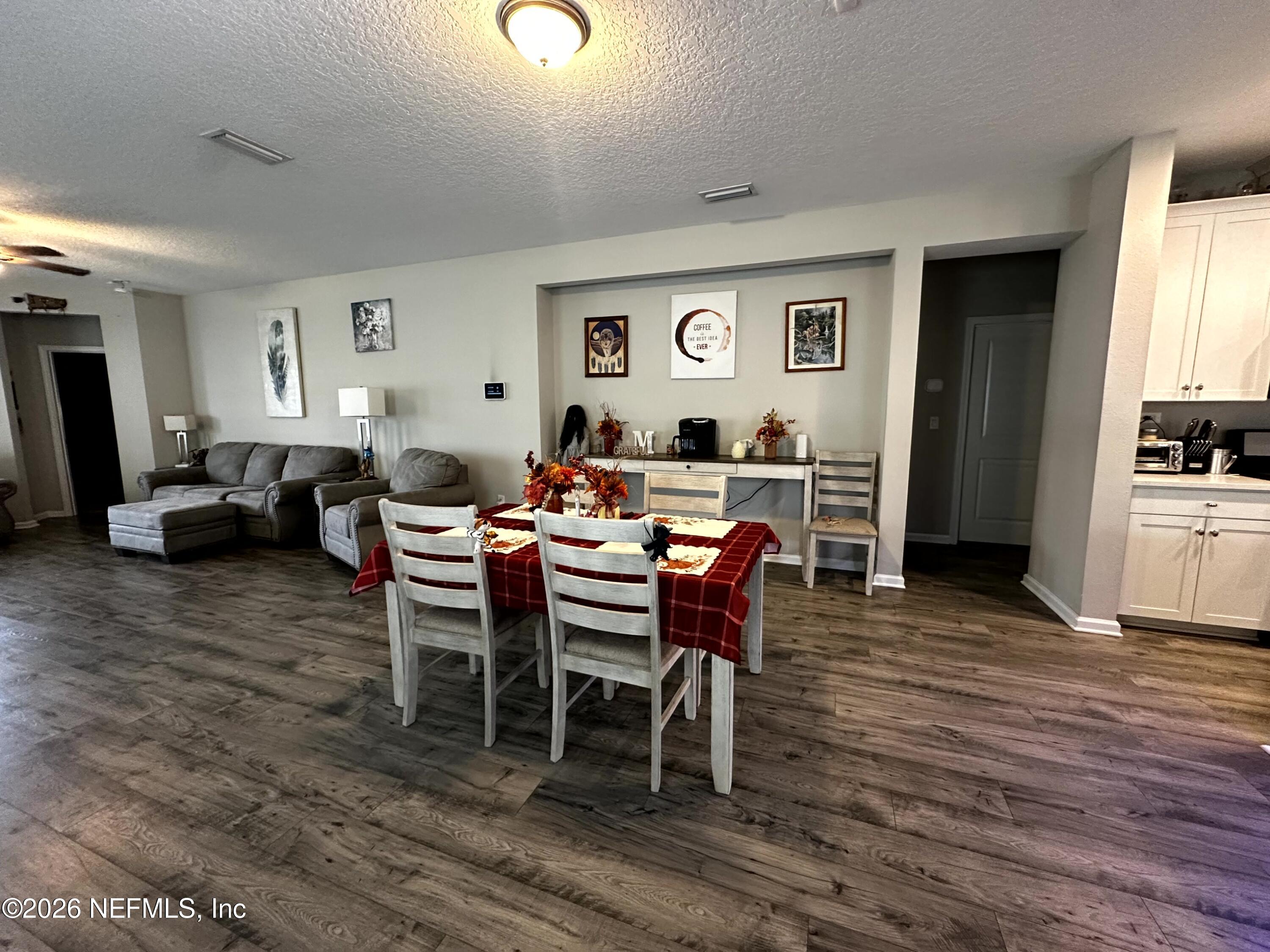 177 Clarys Run St. Augustine, FL 32092 - Photo 12 of 16 a dining room with furniture a rug and wooden floor